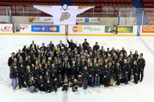 Kevin Oman/For the Sun
Some of the hundreds of MasterCard Memorial Cup volunteers pose for a photo with the Memorial Cup at Westman Place on Saturday.