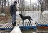 COLIN CORNEAU / BRANDON SUN
Dave Barnes, with his dog Jack, looks over flooding on his property in Brandon’s east end Wednesday.
