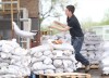 Tim Smith/Brandon Sun
Matthew Cuvelier with Home Depot throws a sandbag onto a pallet during flood evacuation clean-up at the Corral Centre on Saturday. Business owners were allowed into the Corral Centre on Saturday to start getting their businesses ready to re-open on Tuesday.