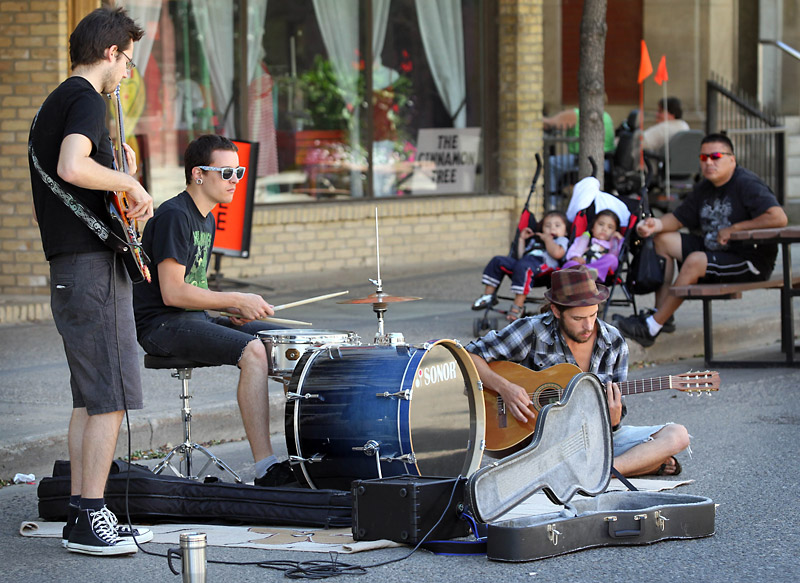 Colin Corneau/Brandon Sun
Nathan Crook, Justin Alcock and Dave Thiel busk along Rosser Avenue near 10th Street on the first day of the block being turned into a pedestrian corridor on Wednesday.