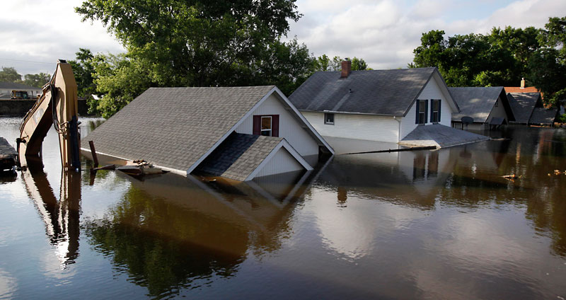 File photo
Floodwaters from the Souir River surround homes and a backhoe in Minot, N.D., on June 27, 2011.
