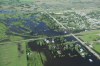 Tim Smith/Brandon Sun
Water inundates the community of Reston, Manitoba, flooding homes on the west side of the community as seen from the air on Wednesday.