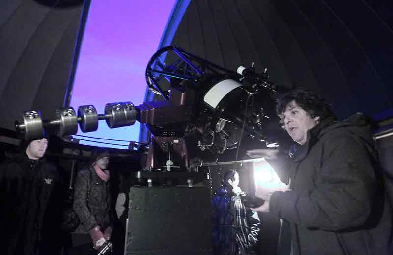 File photo
Brandon University radio astronomer Tyler Foster, right, explains how the moon of Jupiter can be seen through the 16-inch telescope at the BU observatory during an open evening for students and their family and friends in 2012. This past summer, Foster pinpointed what he believes to be the remains of an exploded star — a supernova remnant — and is off to Germany to confirm the discovery.