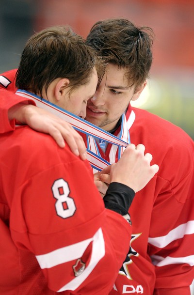 The Associated Press
Jayce Hawryluk, left, and John Quenneville celebrate with their bronze medals after defeating Sweden.