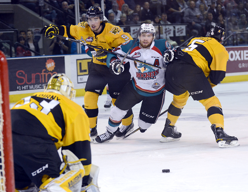 Gary Nylander/The Daily Courier
Kelowna Rocket Rourke Chartier gets caught between Brandon Wheat Kings Ivan Provorov (left) and Colton Waltz.