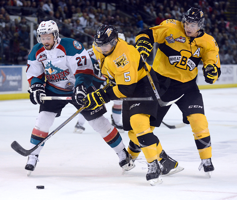 Gary Nylander/The Daily Courier
Kelowna Rockets defenceman Josh Morrissey battles for the puck with Brandon Wheat Kings Colton Waltz (middle) and Eric Roy during the first period of Game 4 of the Western Hockey League final in Kelowna, B.C., on Wednesday evening.