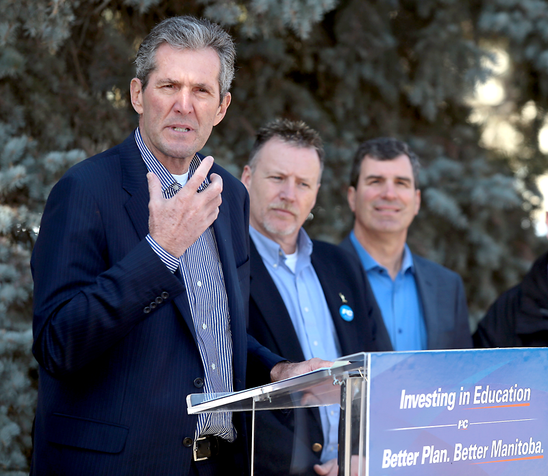 Bruce Bumstead/The Brandon Sun
Progressive Conservative Leader Brian Pallister speaks outside Clark Hall on the Brandon University campus during an announcement on post-secondary grant funding on Monday, while Brandon East Tory candidate Len Isleifson and Brandon West PC incumbent Reg Helwer look on.