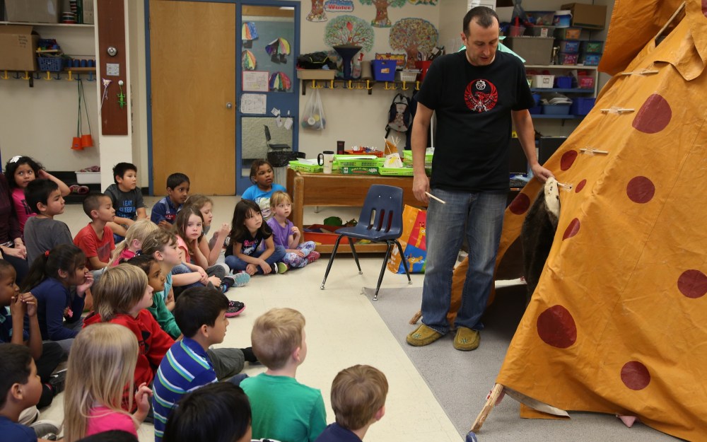 Alex Antoneshyn/The Brandon Sun
Joe Lanceley, a.k.a. Tipi Joe, right, explains to a Meadows School Grade 1/2 class that beaver hides are often used to cover the opening of a teepee in cold weather during a visit to the school on Friday.