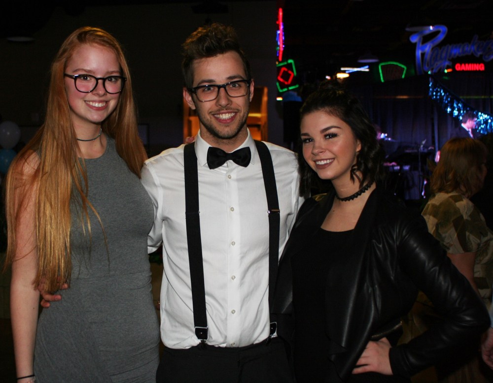 Mariah Phillips/For The Sun
Emily Karrouze, left, Nick Slota and Jenna Karrouze ring in the new year at Canad Inns on Saturday.