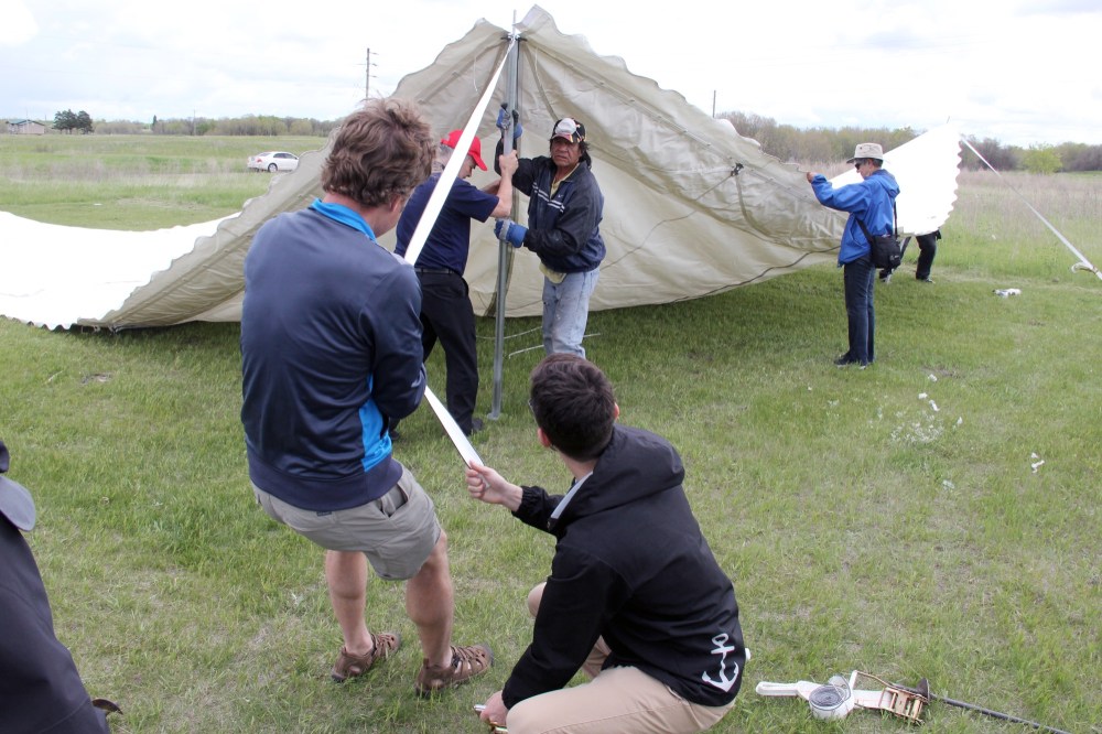 Ian Froese/The Brandon Sun
Residents of Birdtail Sioux First Nation and visiting Presbyterian Church in Canada members worked together to put up a tent that will be a substitute for the community's church as it undergoes repairs.