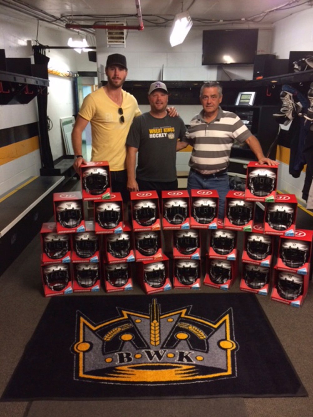 Submitted
Joel Edmundson of the St. Louis Blues poses with Brandon Midget AAA head coach Tyson Ramsey and Bruce Moar of the team executive after donating 25 helmets to his former squad.