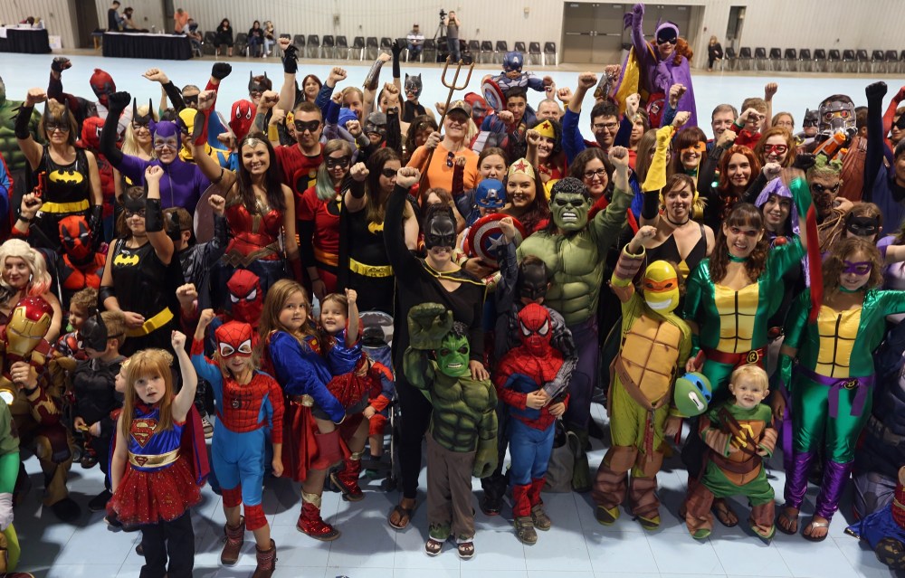 Ian Froese/The Brandon Sun
A gaggle of superheroes, sure to keep Brandon safe from the bad guys, raise their fists in unison at the Be A Superhero in the Fight Against Cancer world record attempt Sunday afternoon at the Keystone Centre's Manitoba Room. They fell well short of their goal, but organizers consider it a success because money was raised for cancer research.