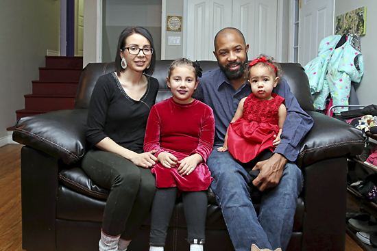 Julia Stoneman-Sinclair, her partner Kasey Batson and their children Shaynen and Naira Batson, pose for a photo in the living room of their home in Brandon. Stoneman-Sinclair is currently battling stage four colorectal cancer. (Tim Smith/The Brandon Sun)