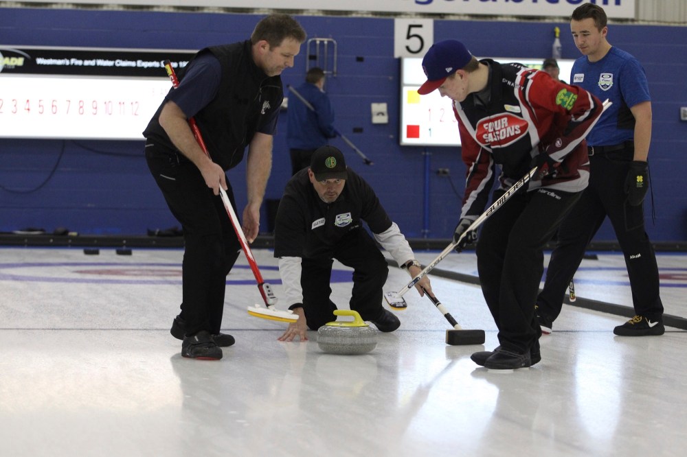 Chris Jaster/The Brandon Sun
Virden skip Graham Freeman watches his stone as Cory Barkley, left, and Brooks Freeman prepare to sweep it during the 127th annual Brandon Men's Bonspiel competitive division final against Winnipeg's Brett Walter at the Brandon Curling Club on Sunday.