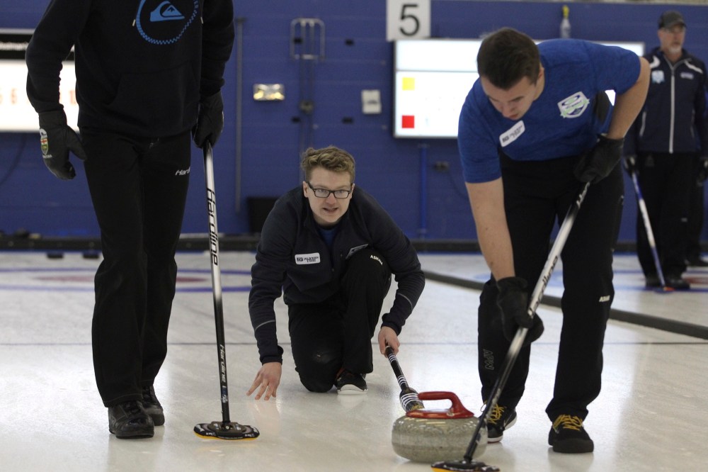 Chris Jaster/The Brandon Sun
Brett Walter watches his stone as Chase Dusessoy sweeps it during the 127th annual Brandon Men's Bonspiel competitive division final against Virden's Graham Freeman at the Brandon Curling Club on Sunday. Walter won 6-4 but Freeman earned a berth to the Viterra Championship.