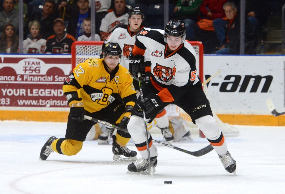 Ryan McCracken/Medicine Hat News
Medicine Hat Tigers defenceman Kristians Rubins handles the puck in front of Brandon Wheat Kings captain James Shearer during Game 2 of their WHL Eastern Conference quarter-final on Sunday at the Canalta Centre in Medicine Hat.