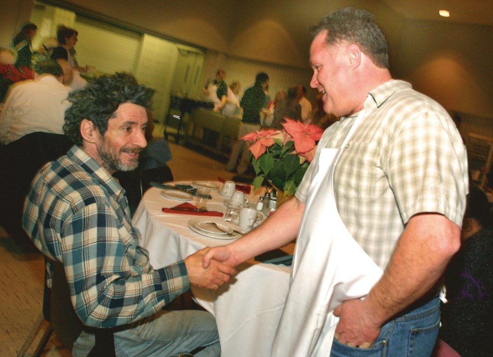 File
Gladden Smith, right, greets Percy Bercier during the Westman Traditional Christmas Dinner at the Keystone Centre in 2005.