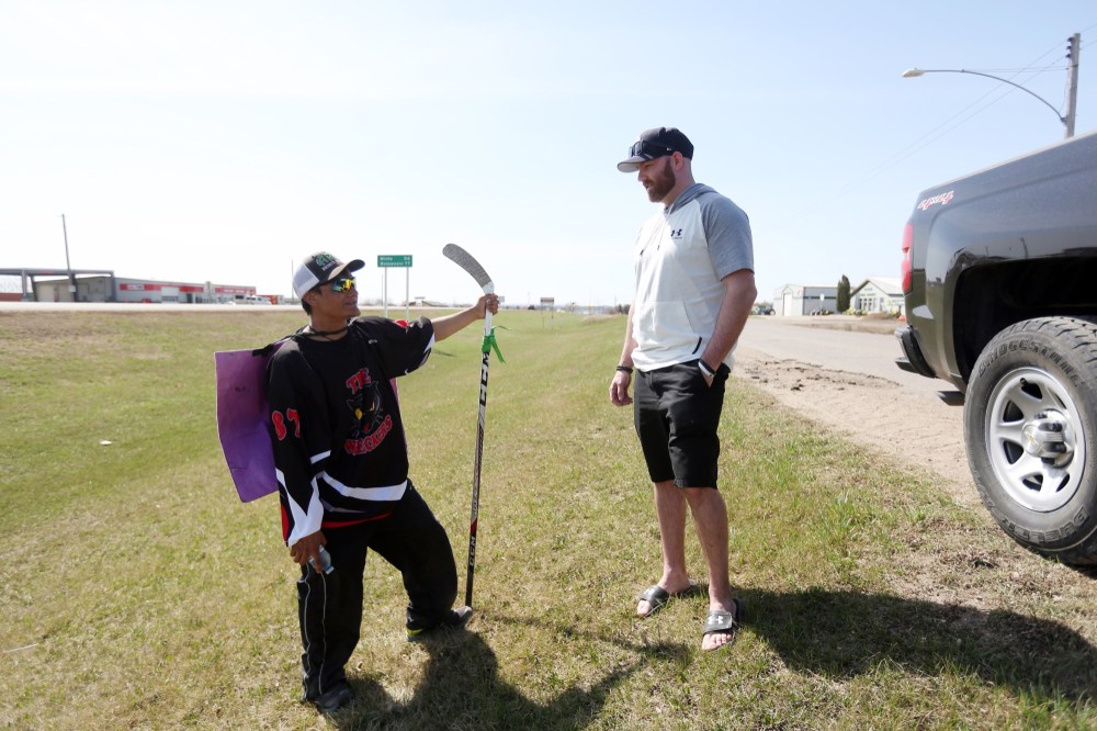 Michael Lee/The Brandon Sun
Brayden Higham, right, pulled over to the side of the road so he could offer Rance Cardinal some words of encouragement as he walks across the Prairies to Humboldt, Sask.