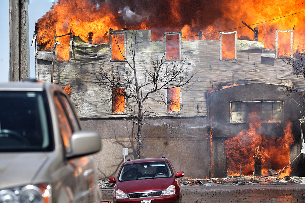 Matt Goerzen/The Brandon Sun
The front of the Christie's Office Plus building as it burns Saturday afternoon, seen looking north from Seventh Street in Brandon.