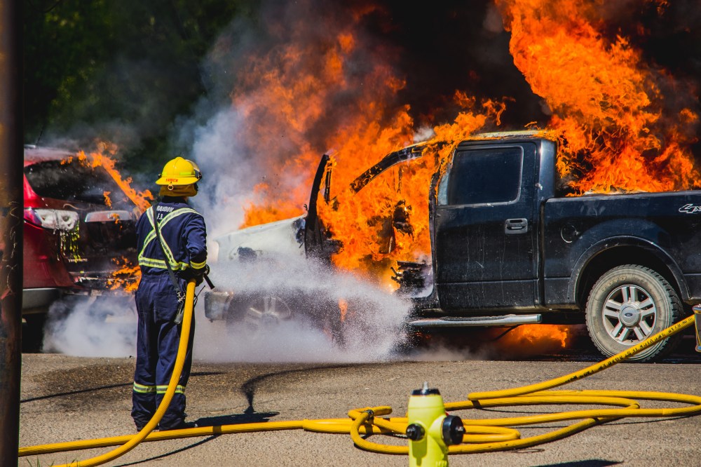 JUSTIN OERTEL
A firefighter tries to put out a vehicle fire at Pacific Avenue and 10th Street on Sunday. The City of Brandon said the fire was due to a mechanical issue and unrelated to the structure fires.