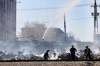 Matt Goerzen/The Brandon Sun
Firefighters and investigators with the Office of the Fire Commissioner sift through the rubble of the Christie's Office Plus building on Sunday morning.