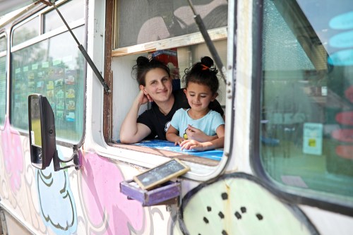 08062018
Morgan Ahmed and her daughter Zaara, 4, look out from their popular ice-cream spot, Mad Dog Ice Cream, in Forrest, Manitoba.  (Tim Smith/The Brandon Sun)