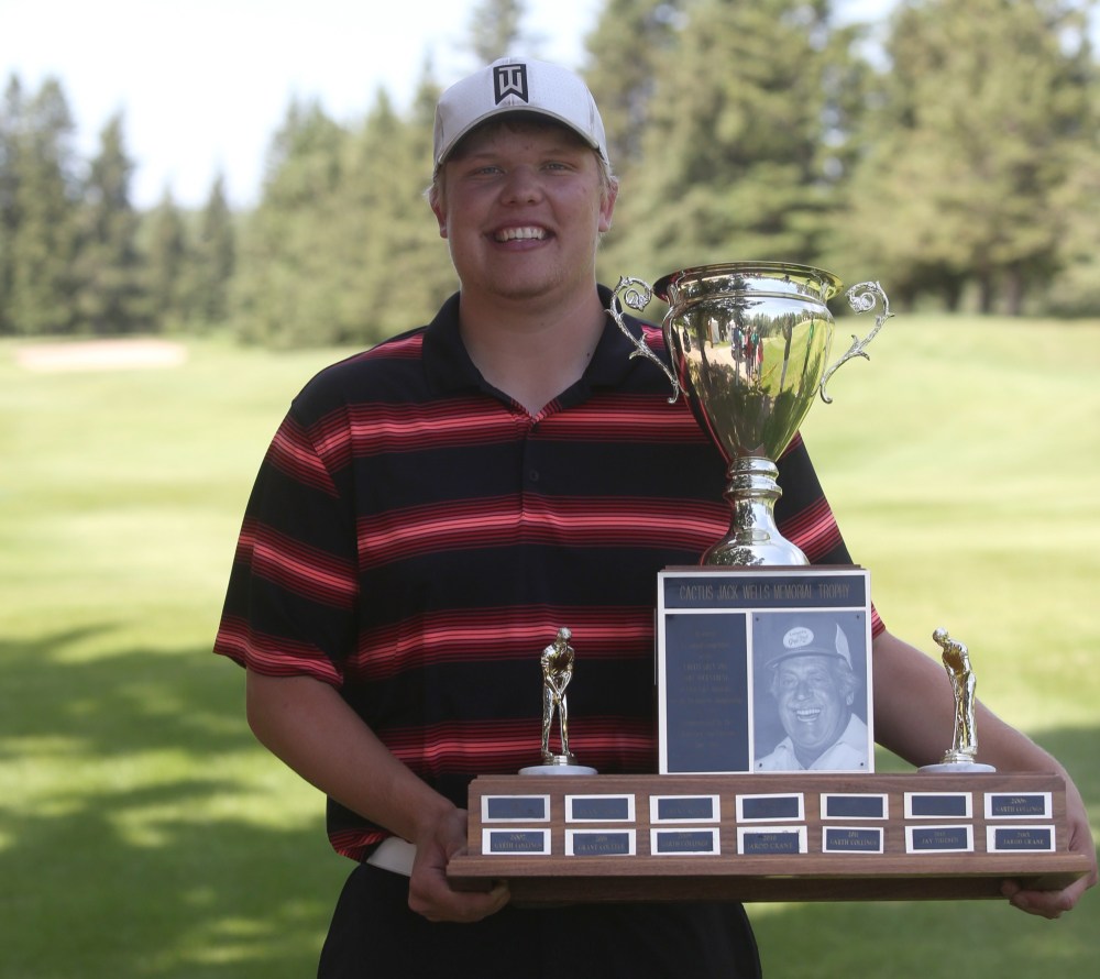 Chris Jaster/The Brandon Sun
Nick Myhre poses with the Cactus Jack Wells Memorial Trophy after winning his second straight Grey Owl golf tournament at the Clear Lake Golf Course on Sunday.