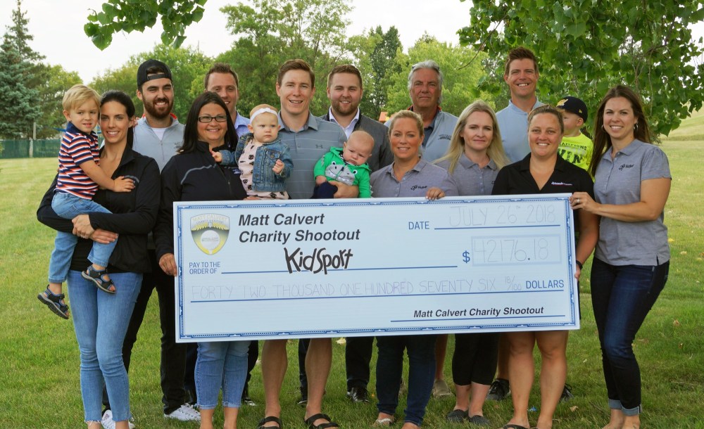 Submitted
Matt Calvert, surrounded by friends, family, sponsors and committee members, presents a cheque to KidSport. The $42,176 cheque represents the net proceeds of the 2018 Matt Calvert Charity Shootout played at the Wheat City Golf Course on June 28. Calvert, a National Hockey League player and former member of his hometown Brandon Wheat Kings, was quick to point out that “the committee did a great job on the event” and he basically just had to show up. “We just had a meeting and plans are underway for year three with the charity of choice yet to be named.”
