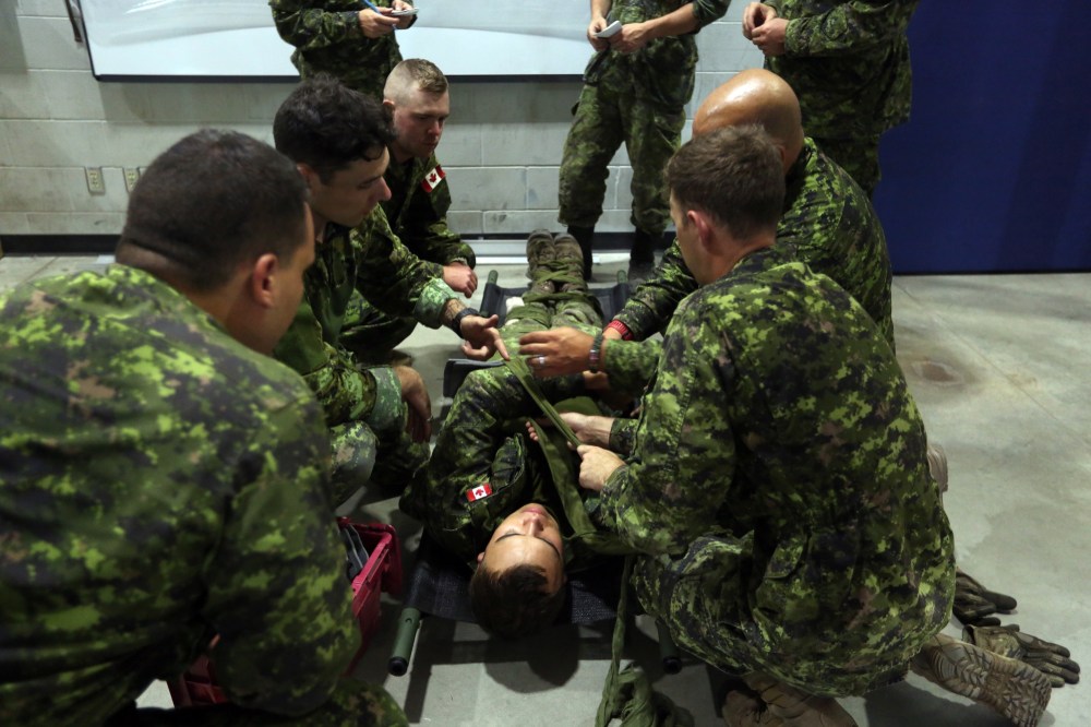 A group of soldiers from 2nd Battalion, Princess Patricia's Canadian Light Infantry perform first aid on Friday during a skills competition at CFB Shilo. (Michael Lee/The Brandon Sun)