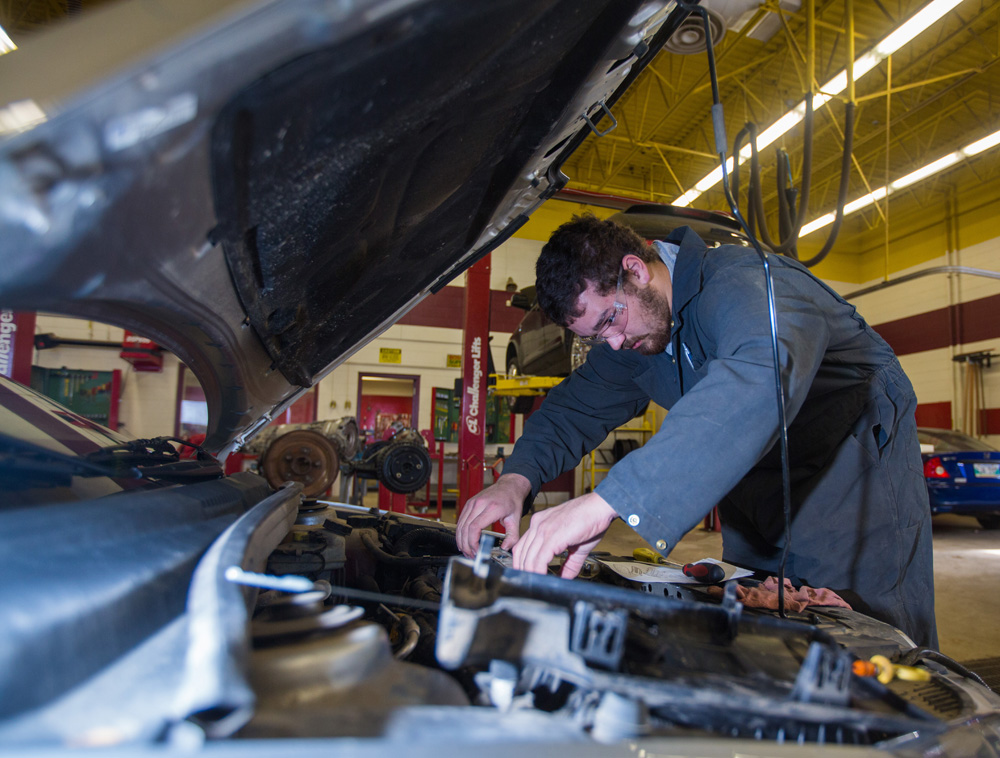 Grade 12 student Gavin Reid gets to work on a car at the Crocus Plains Regional Secondary School Automotive Technology classroom Thursday. (Chelsea Kemp/The Brandon Sun)