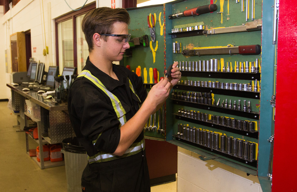 Grade 12 student Keagan Hudson selects a tool of his trade at the Crocus Plains Regional Secondary School Automotive Technology classroom Thursday. (Chelsea Kemp/The Brandon Sun)