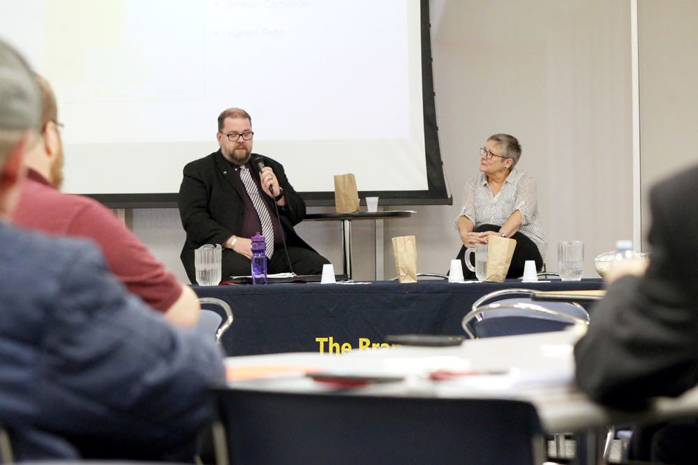 Shaun Cameron, left, and Karen Peto answer questions at a candidates' forum at Brandon University on Wednesday. (Michael Lee/The Brandon Sun)