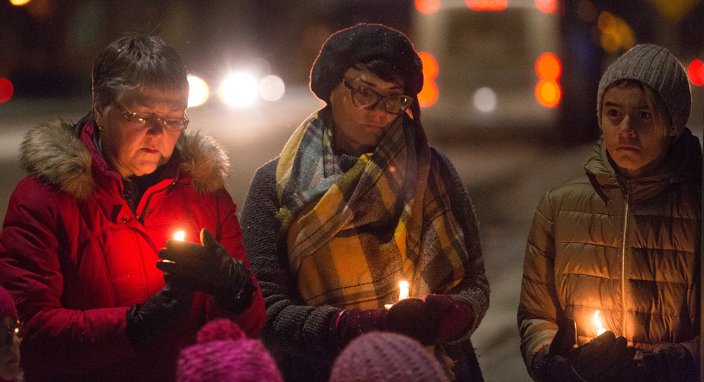 Laura Crookshanks, Allison McCulloch and Xavier McCulloch attend the Trans Day of Remembrance candlelight vigil at Knox United Church Tuesday. (Chelsea Kemp/The Brandon Sun)