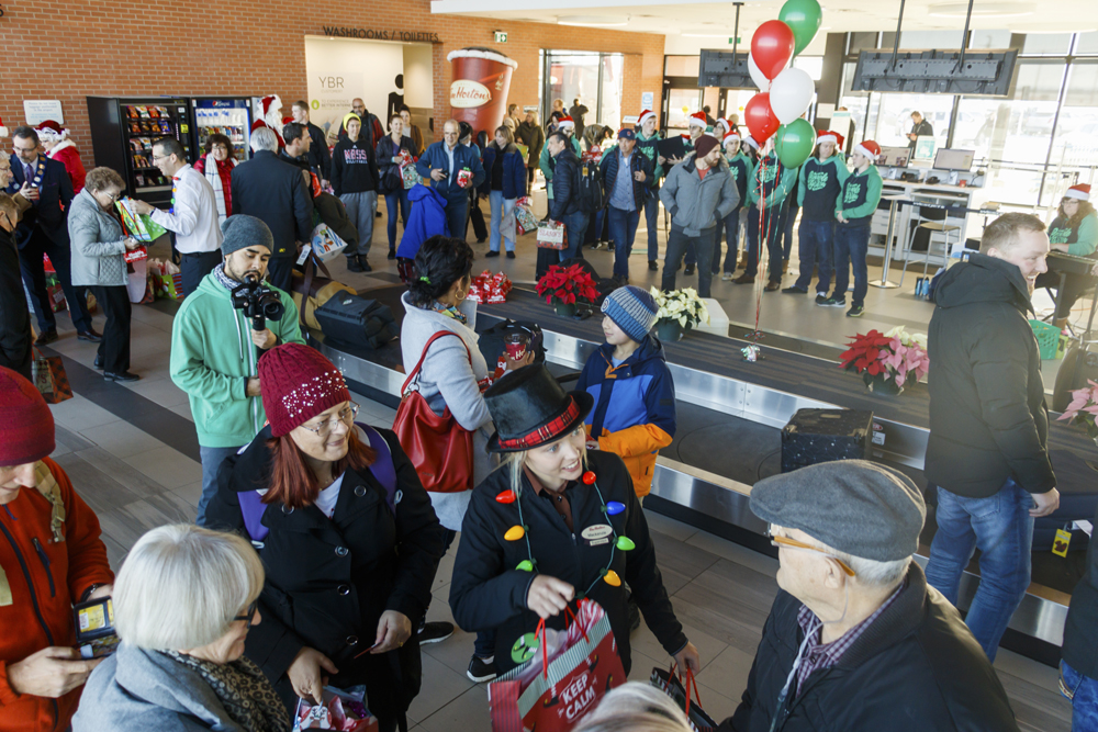 Guests arriving at the Brandon Municipal Airport Friday are greeted with Christmas carols, presents and holiday cheer from Tim Hortons franchises in Brandon, Virden and Neepawa. (Chelsea Kemp/The Brandon Sun)