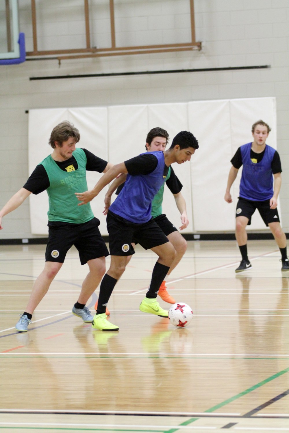 Diego Rodriguez, shown shielding the ball against Kristen Bender, left, and Cole Goyak during Brandon University Bobcats men's futsal practice at the Healthy Living Centre on Tuesday, was an all-conference futsal player in 2018.