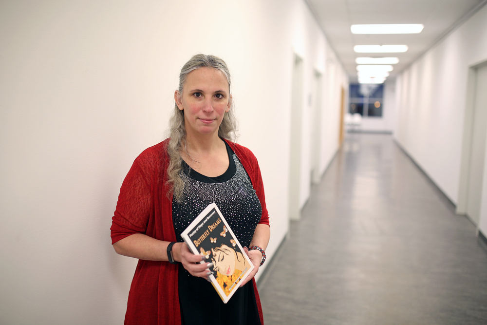 Michelle Budiwski with her book Butterfly Dreams during her book launch at the Art Gallery of Southwestern Manitoba on Thursday evening. (Tim Smith/The Brandon Sun)