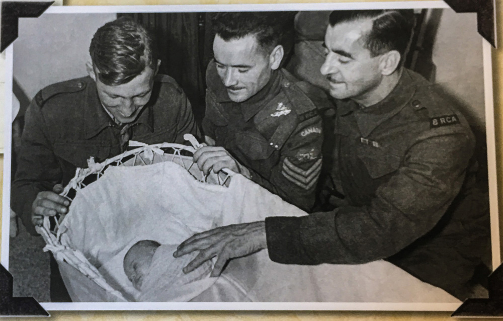 Royal Canadian Artillery members Ernest (Ernie) Curtis, Bob Griffin and A.J. Bracket pictured with baby Mary Crabb. (Submitted)