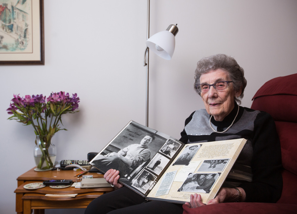 Winelda Curtis poses with a scrapbook commemorating the life of her late husband Ernie Curtis Saturday. (Chelsea Kemp/The Brandon Sun)