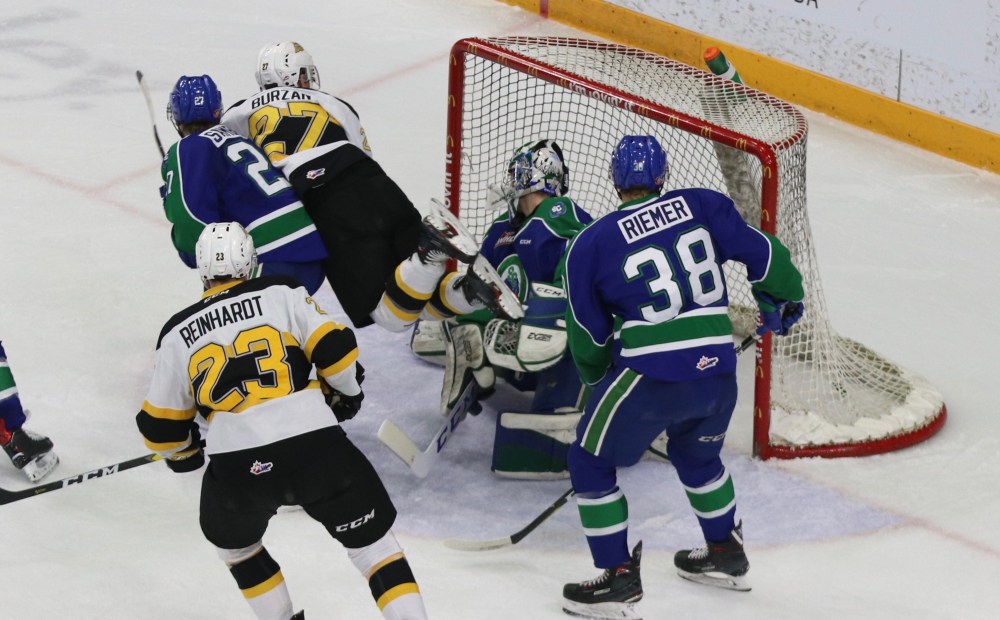 Perry Bergson/The Brandon Sun
Brandon Wheat Kings forward Luka Burzan flies through the air as he scores the tying goal in the third period of a Western Hockey League game against the Swift Current Broncos on Monday at Westoba Place. Broncos goalie Isaac Poulter of Winnipeg is flanked by defenceman Garrett Sambrook of Medora (27) and Christian Riemer (38), along with Wheat Kings forward Cole Reinhardt, who scored the game winner in overtime.