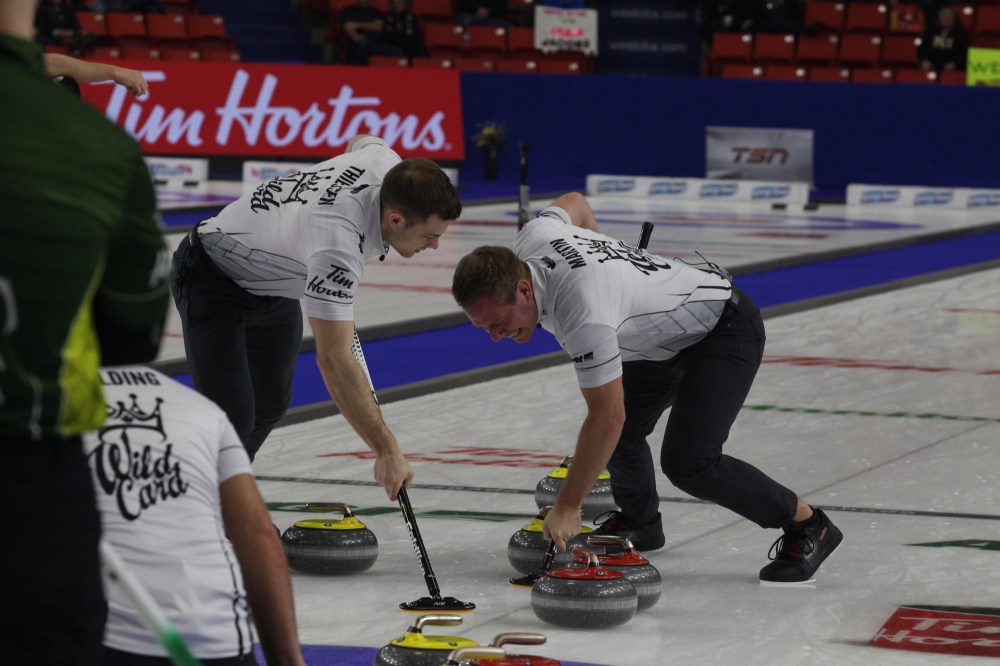 Chris Jaster/The Brandon Sun
Karrick Martin, left, and Brad Thiessen of Team Wild Card sweep a rock through a port during the 10th end of their Tim Hortons Brier semifinal against Northern Ontario's Brad Jacobs at Westoba Place on Sunday. (Chris Jaster/The Brandon Sun)