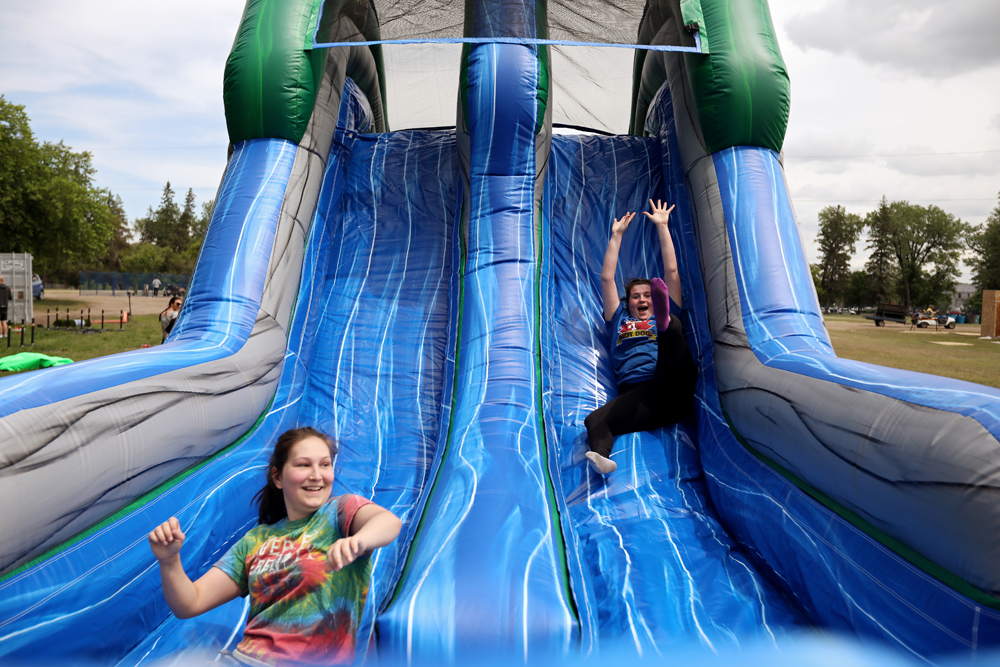 Staff try out an inflatable obstacle course while setting up the Brandon Bouncy Castles summertime water park at the Keystone Centre grounds on Tuesday afternoon.  (Tim Smith/The Brandon Sun)
