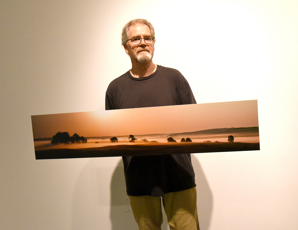 Brandon photographer Doug Derksen holds one of his pieces that will be on display in a summer exhibition at the Art Gallery of Southwestern Manitoba. (Bud Robertson/The Brandon Sun)
