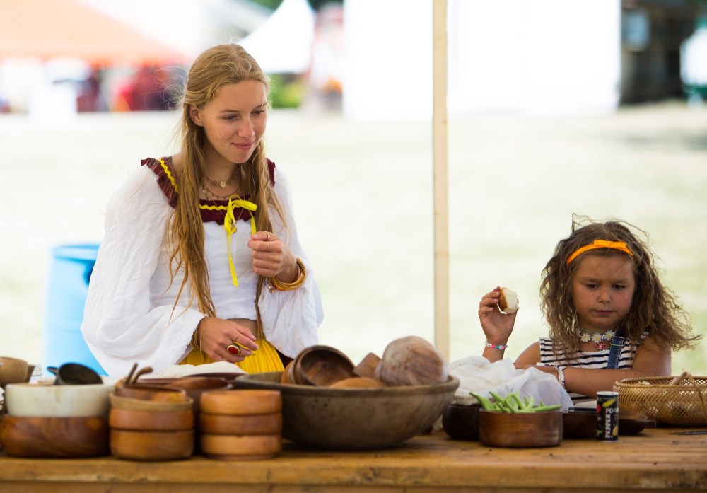 Chelsea Kemp/The Brandon Sun
Camryn Chetyrbuk, left, and Alina Genik, 8, check out traditional food prepared at the Cossack Village.