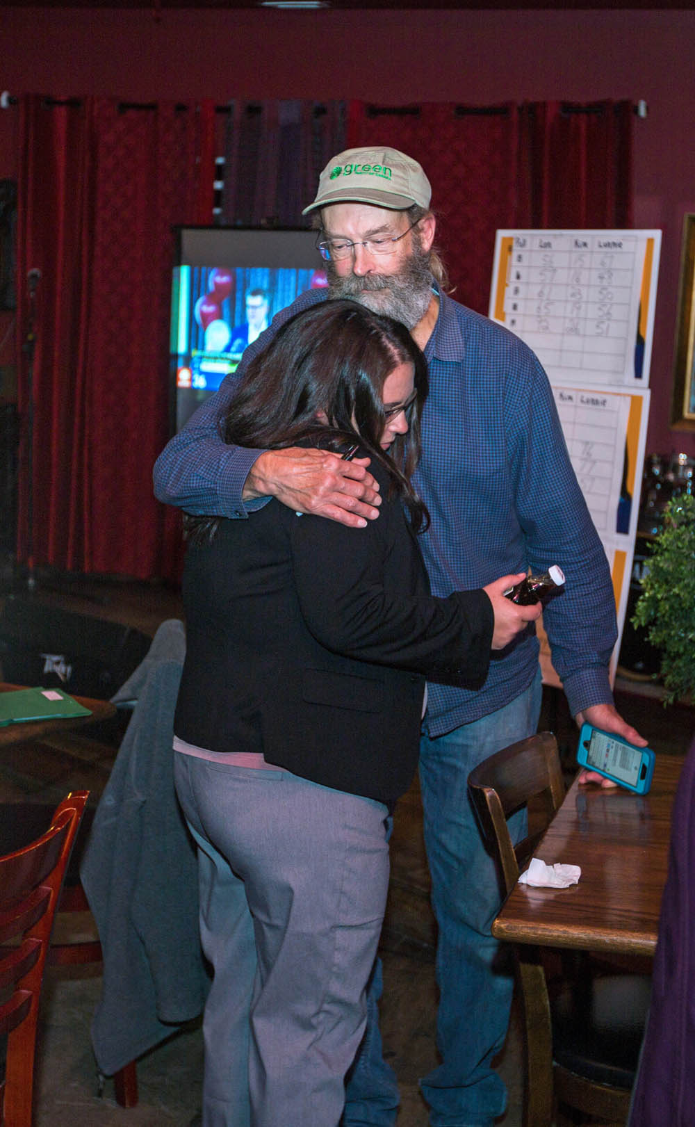 Brandon East NDP candidate Lonnie Patterson hugs supporter Dave Barns at the NDP headquarters at Lady of the Lake Tuesday. (Chelsea Kemp/The Brandon Sun)