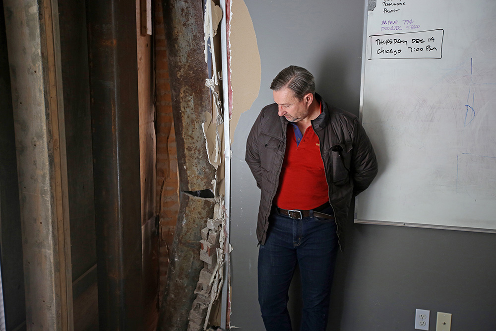 Samson Engineering senior engineer and president Phil Dorn looks over the damage in his office on 10th Street, which includes a sheered iron support column. (Tim Smith/Brandon Sun)