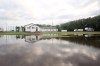 Buildings are reflected in a pool of rainwater from Sunday's storms at the corner of 17th Street East and Richmond Avenue on Monday morning. (Matt Goerzen/The Brandon Sun)