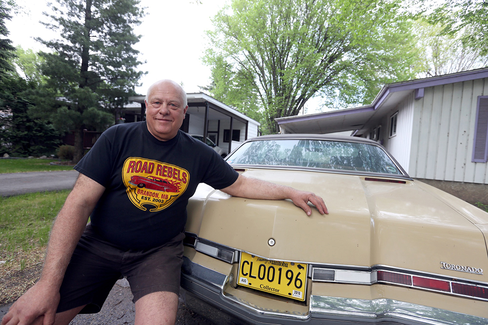 Dave Burba poses for a picture with his 1975 Oldsmobile Toronado in 2018. The Road Rebels president was putting together a major exhibit for the 2020 World of Wheels convention in Winnipeg before it was cancelled last weekend due to concerns about the coronavirus. (File)