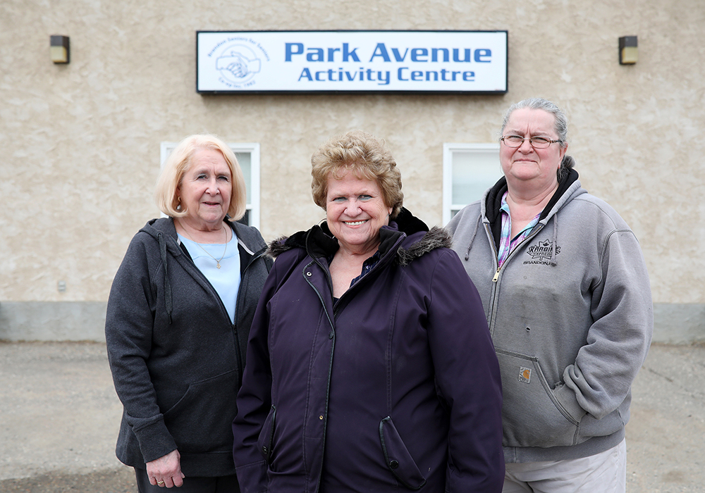 Linda Plowman, Margaret Schonewille and Louise Ross with Brandon Seniors for Seniors outside the Park Avenue activity centre on Tuesday. (Tim Smith/The Brandon Sun)