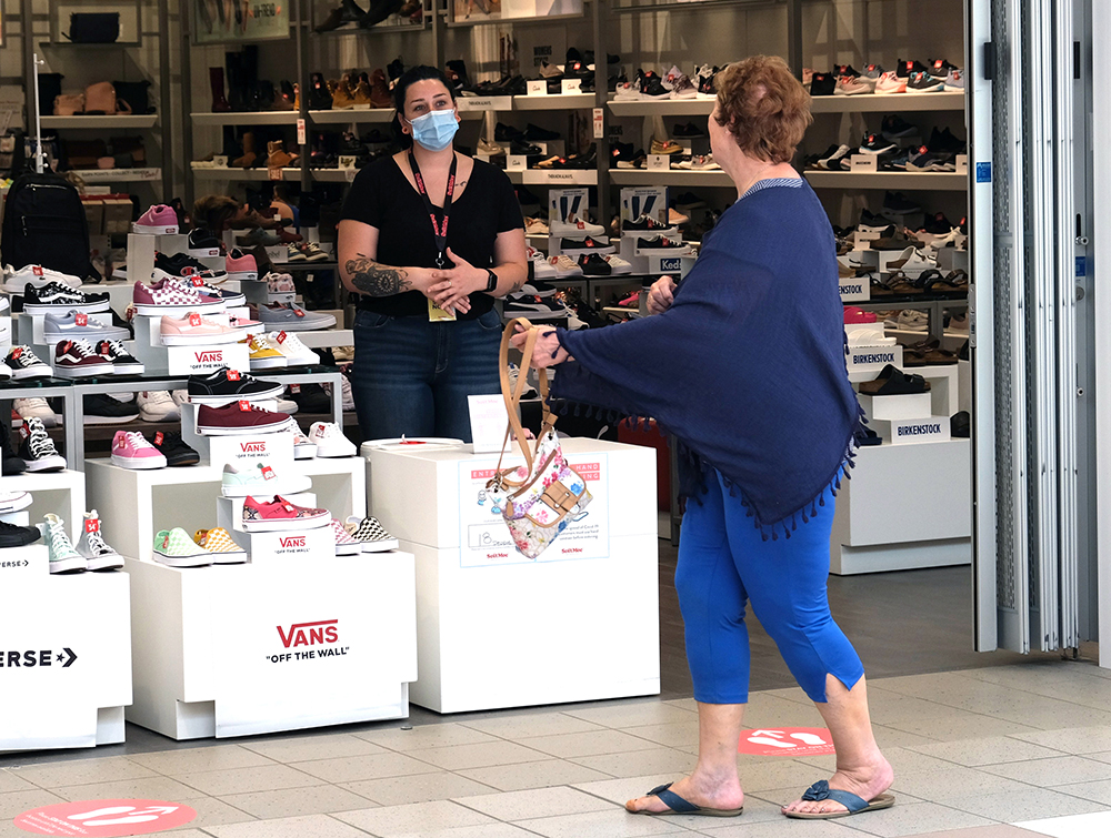 Soft Moc sales clerk Chaelynn chats with a passing visitor in the mall.