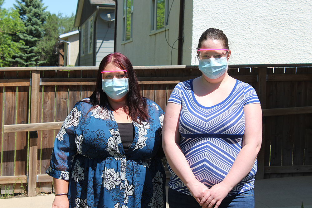 Direct support professionals Lynda Bullee and Tamera Irvine pose for a photo outside a Brandon Community Options house on Friday. While Irvine is a full-time employee for the non-profit agency, who has been working overtime throughout the COVID-19 pandemic, she does not qualify for the province's Risk Recognition Program. Meanwhile, a part-time employee like Bullee is eligible for government funding since she earned less than $6,250 between March 20 and May 29. (Kyle Darbyson/The Brandon Sun)